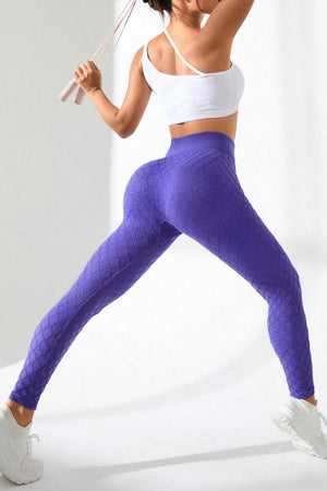 a woman in a white top and purple leggings