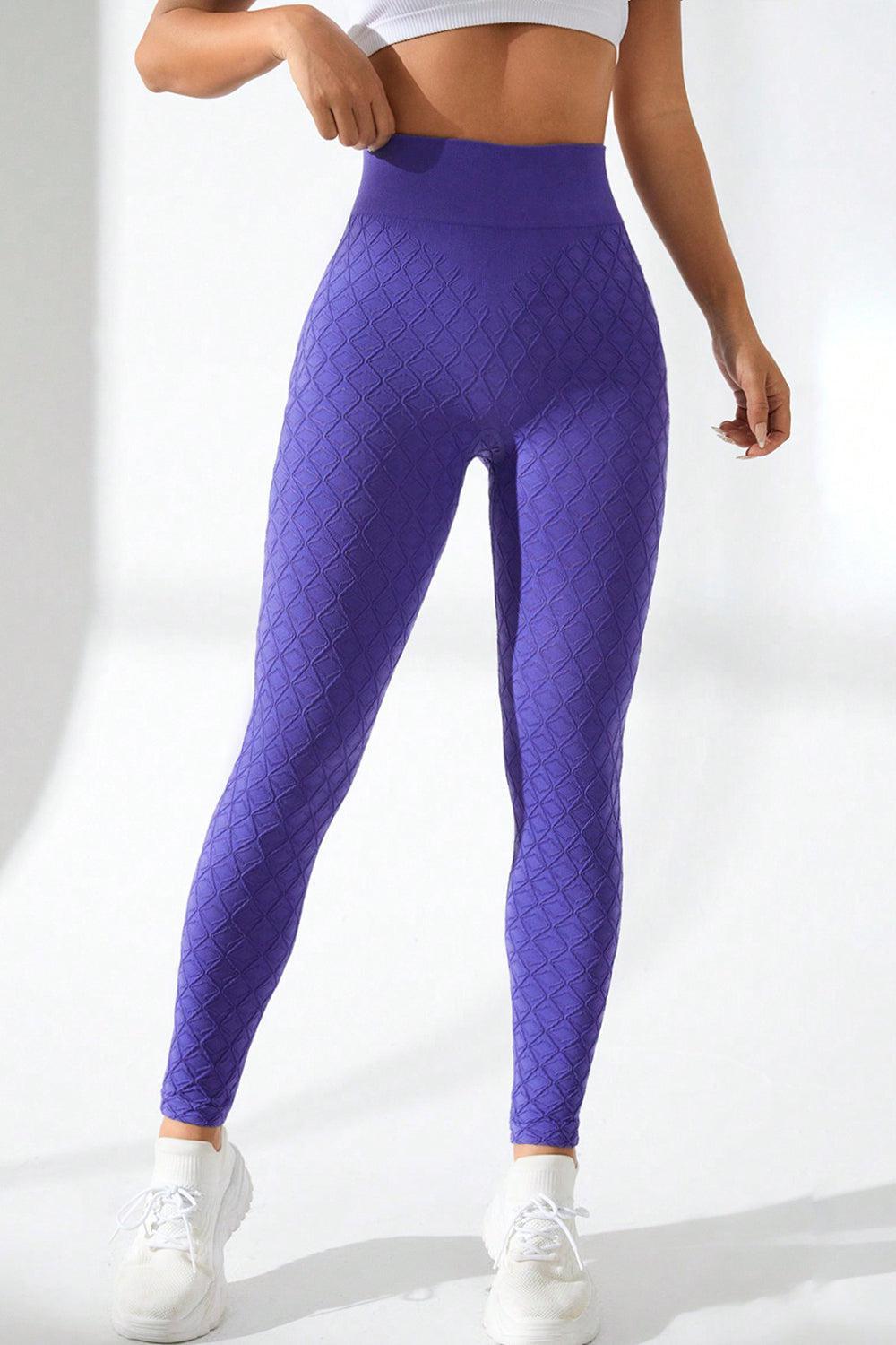 a woman in a white top and purple leggings