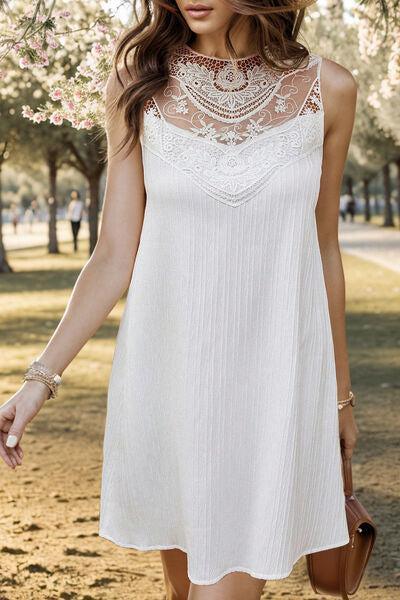 a woman in a white dress is walking in a park