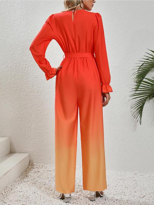 a woman in an orange and yellow jumpsuit