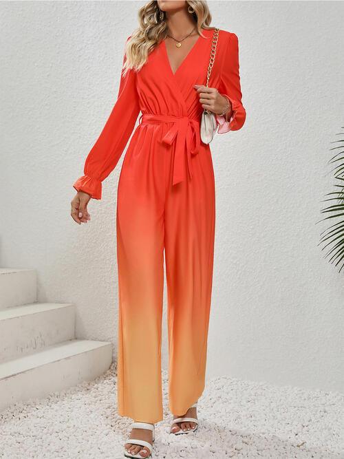 a woman wearing a red and orange ombretta jumpsuit