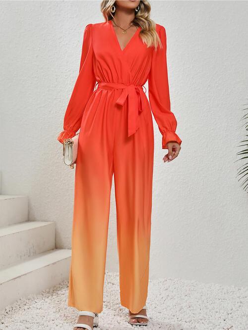 a woman wearing a red and orange ombretta jumpsuit