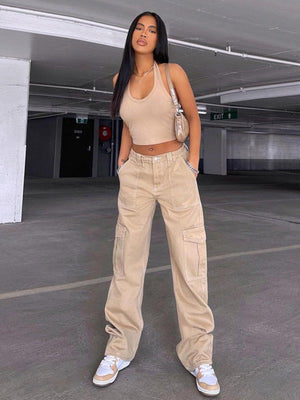 a woman standing in a parking garage with her hands on her hips