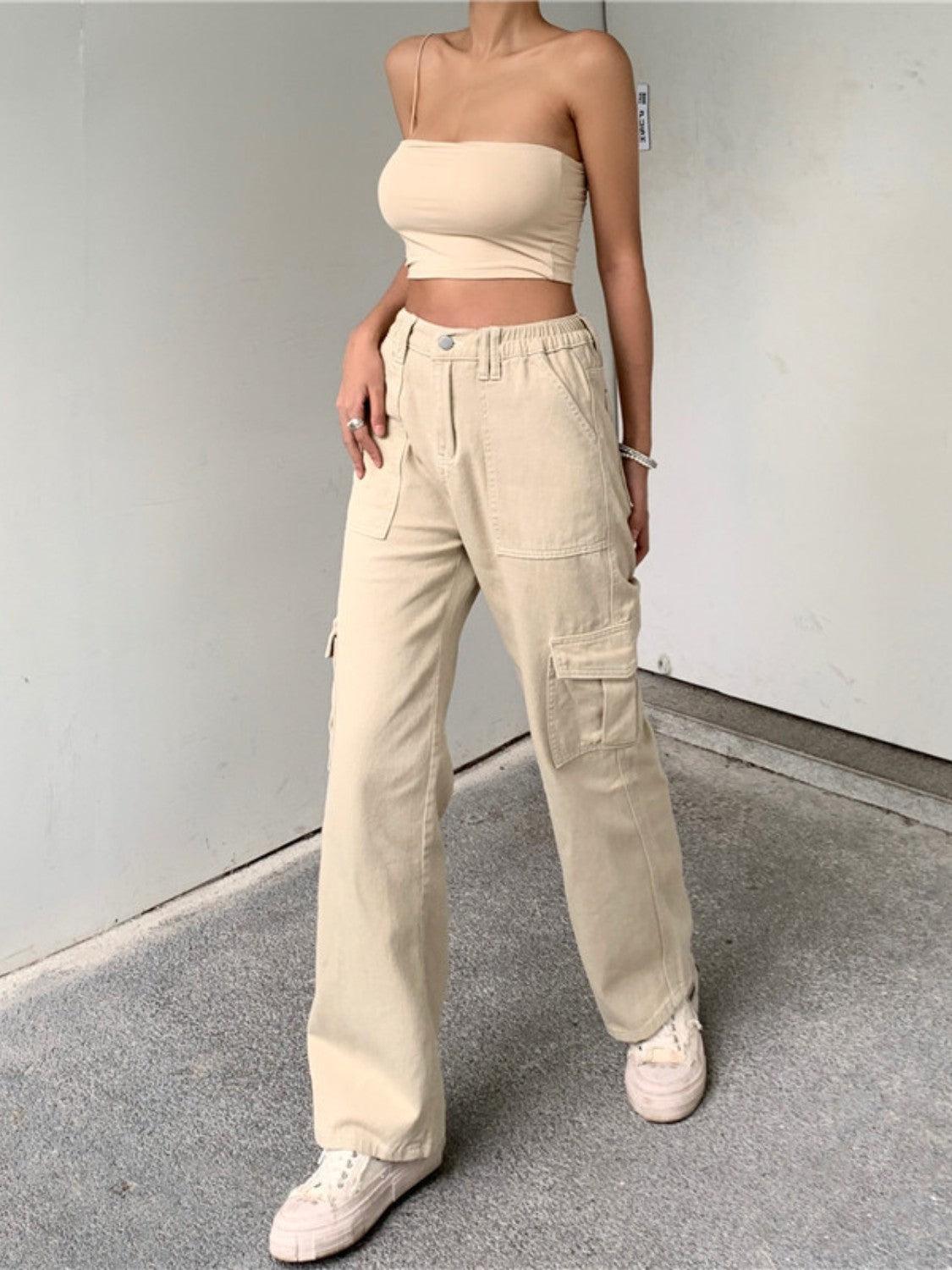 a woman in a crop top and cargo pants