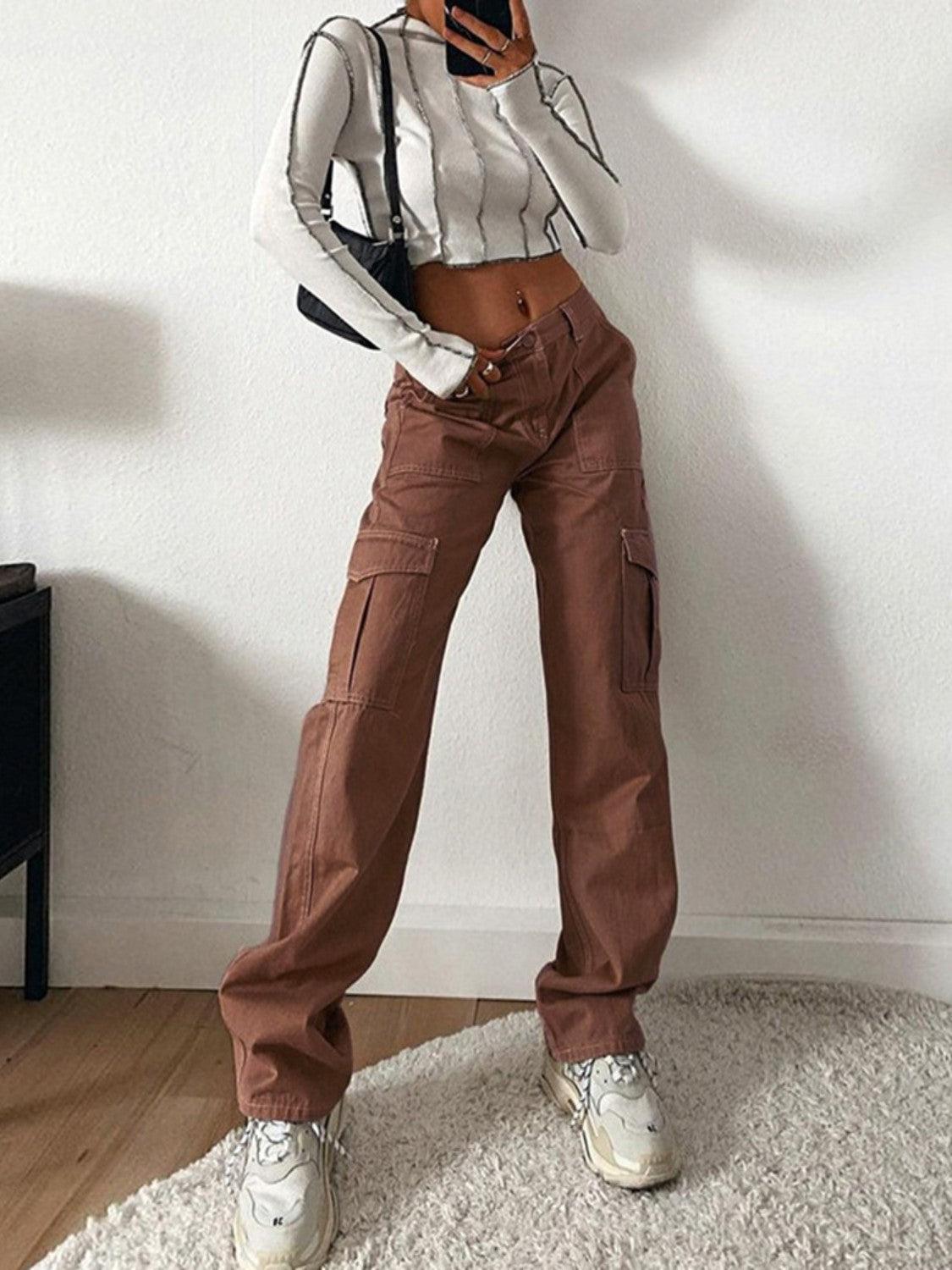 a woman standing in a room with a cell phone