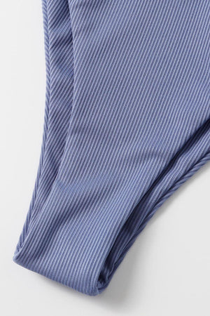 a close up of a blue shirt on a white surface