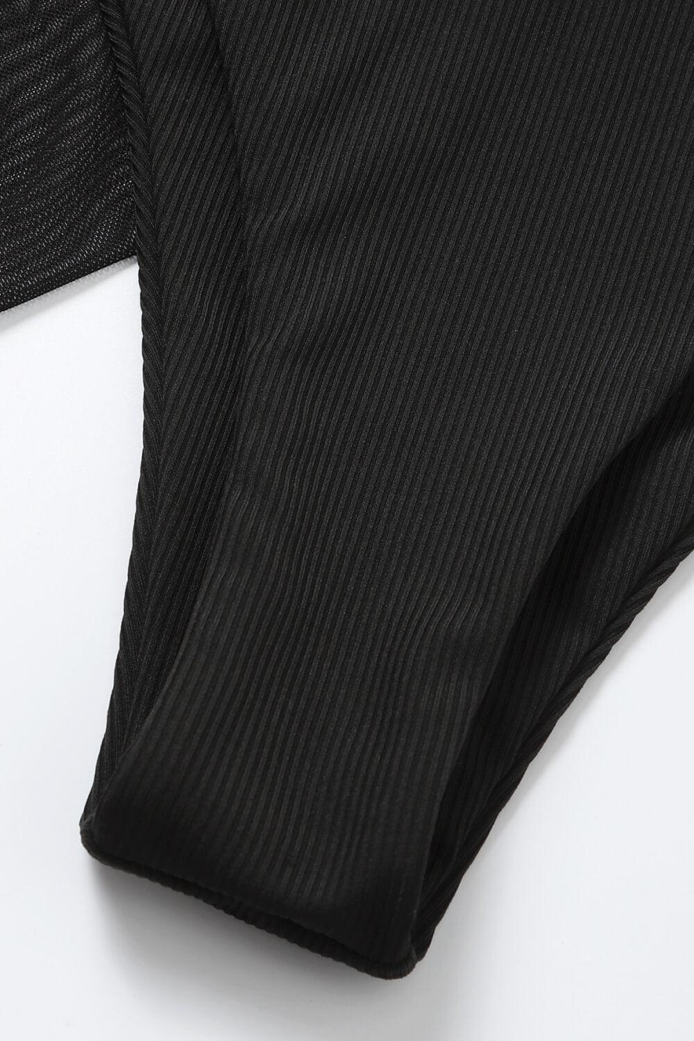 a pair of black underwear on a white surface