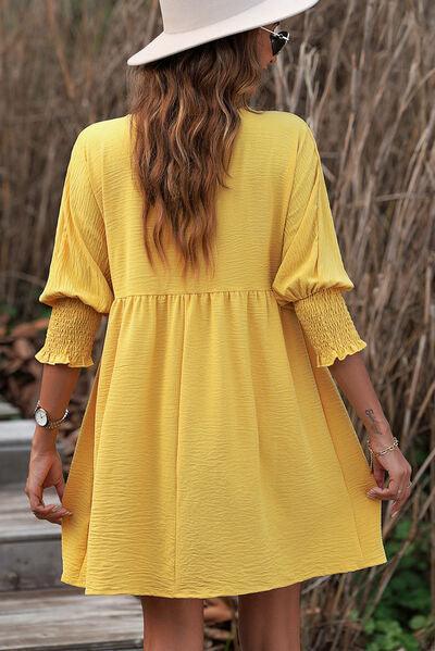 a woman wearing a yellow dress and a white hat