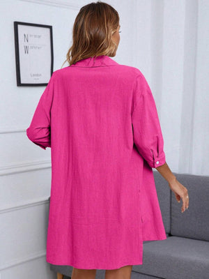 a woman in a bright pink shirt dress