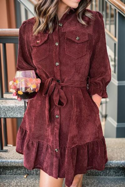 a woman in a red dress is holding a glass of wine