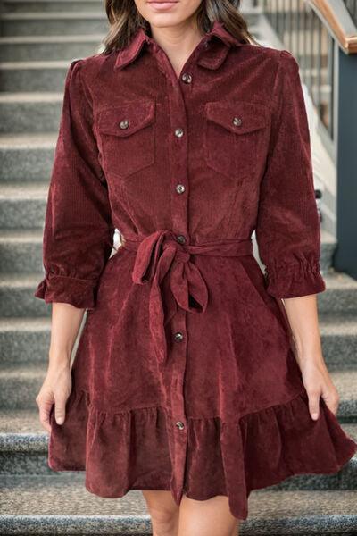 a woman in a red dress is standing on some stairs