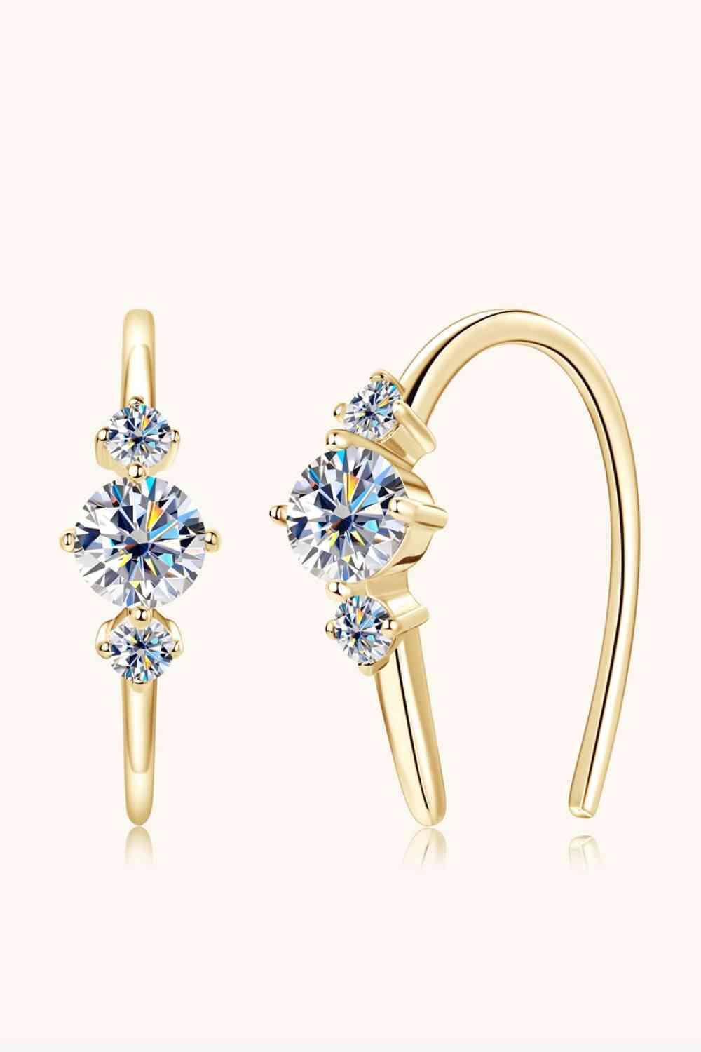 a pair of earrings with a crystal stone