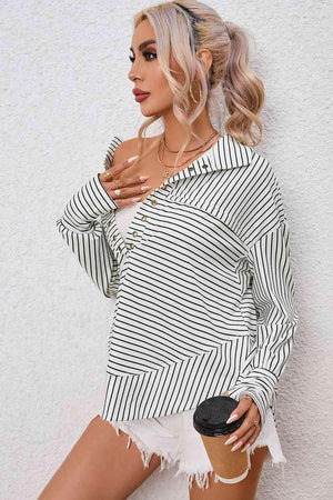 a woman with blonde hair wearing a black and white striped top