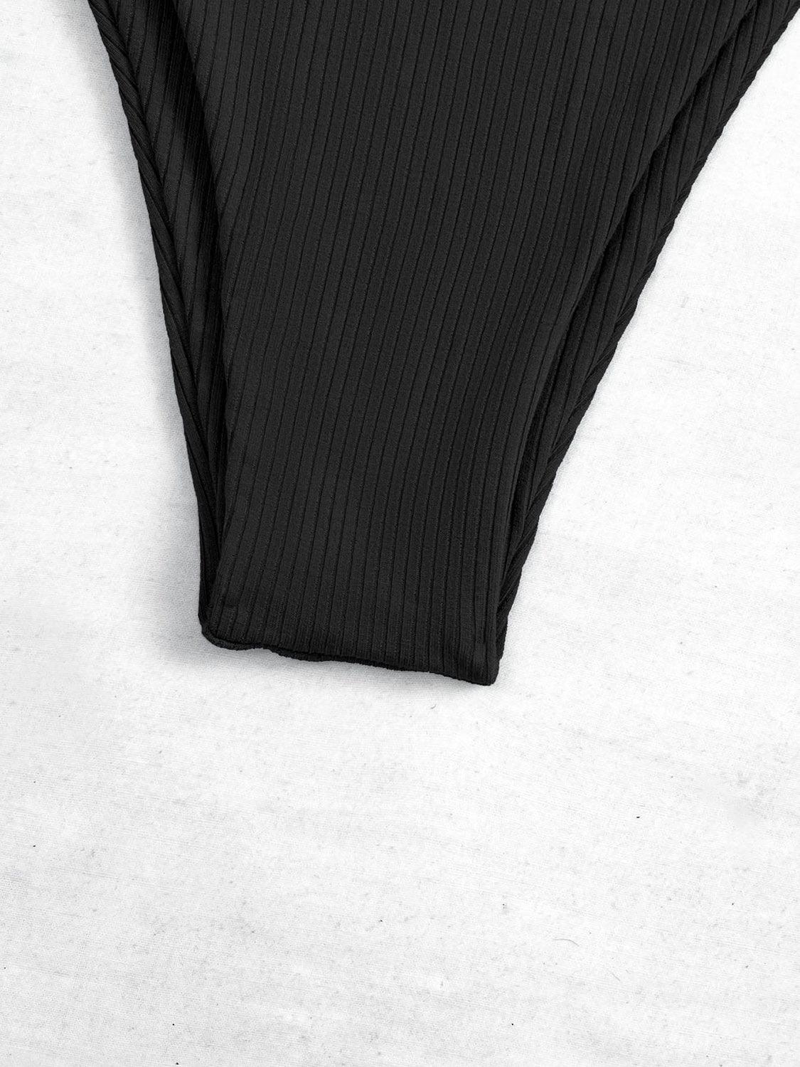 a pair of black underwear sitting on top of a white surface