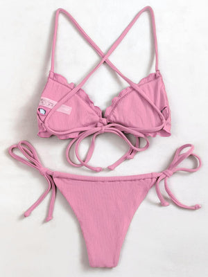 a pink bikini top with a tie around the bottom