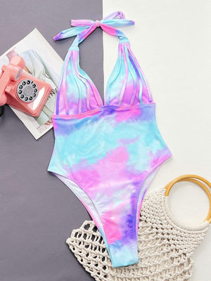 a bathing suit with a tie - dye pattern and a cell phone