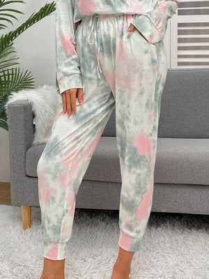 a woman wearing a pink and green tie dye pajamas