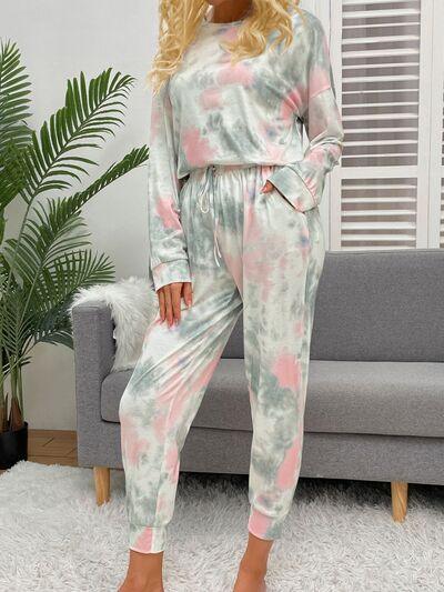 a woman standing in a living room wearing a tie dye set