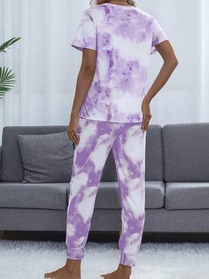 a woman in a purple and white tie dye pajamas