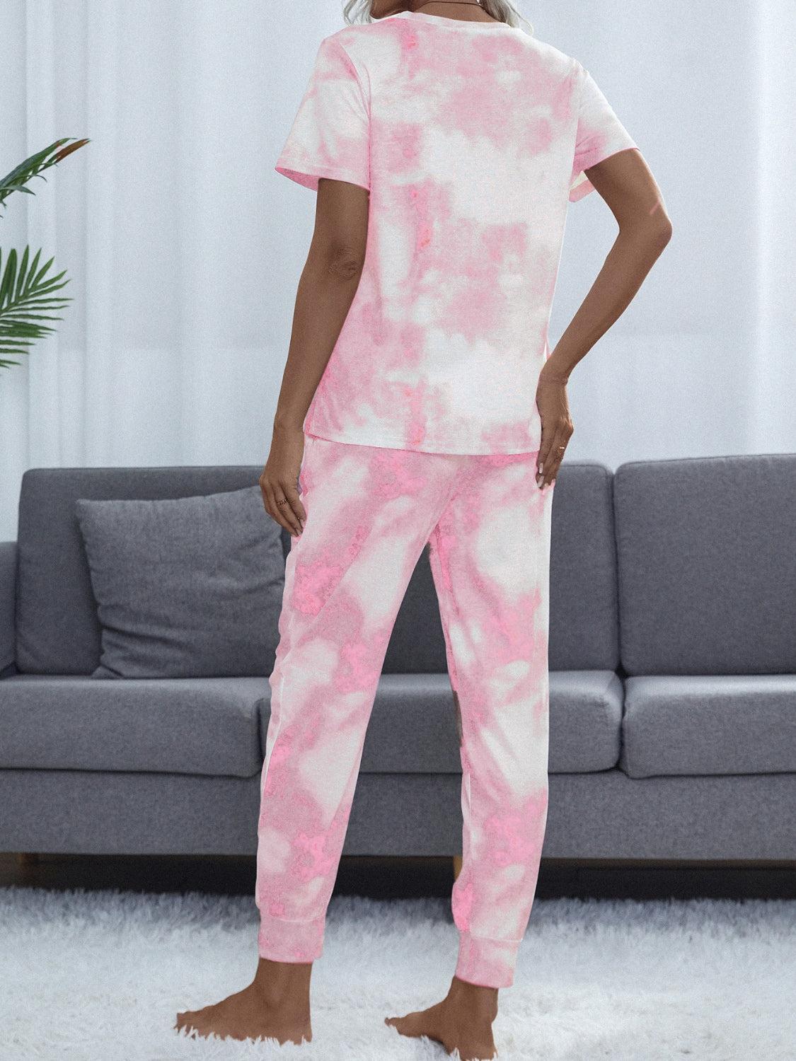 a woman in a pink and white tie - dyed pajama set