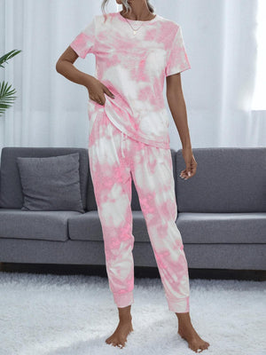 a woman in a pink and white tie dye pajamas