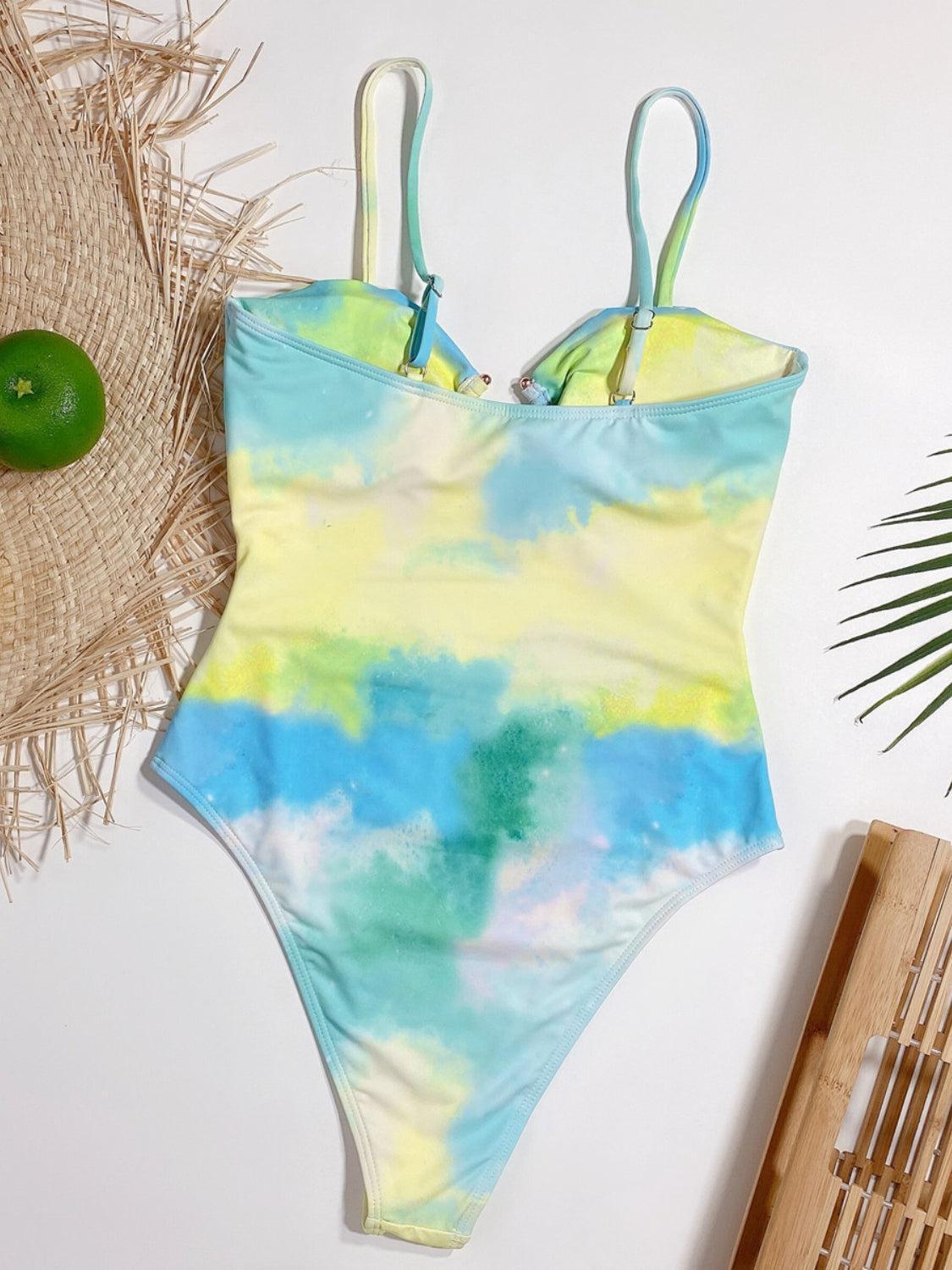 a one piece swimsuit with a tie dye pattern
