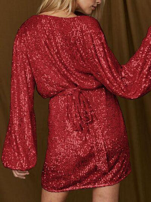 a woman in a red sequin dress