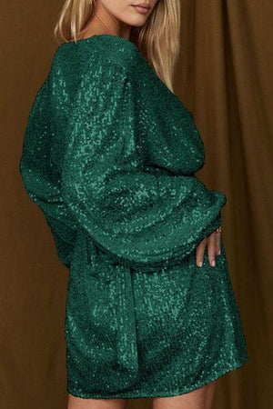 a woman in a green dress posing for a picture