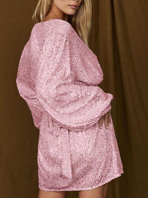 a woman wearing a pink sequin dress