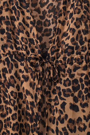 a leopard print shirt with a tie at the waist