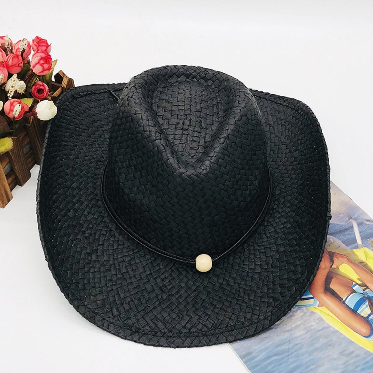 a black hat sitting on top of a magazine