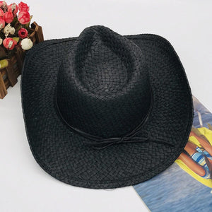 a black cowboy hat sitting on top of a table