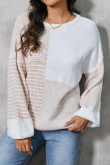 a woman wearing a white sweater and jeans