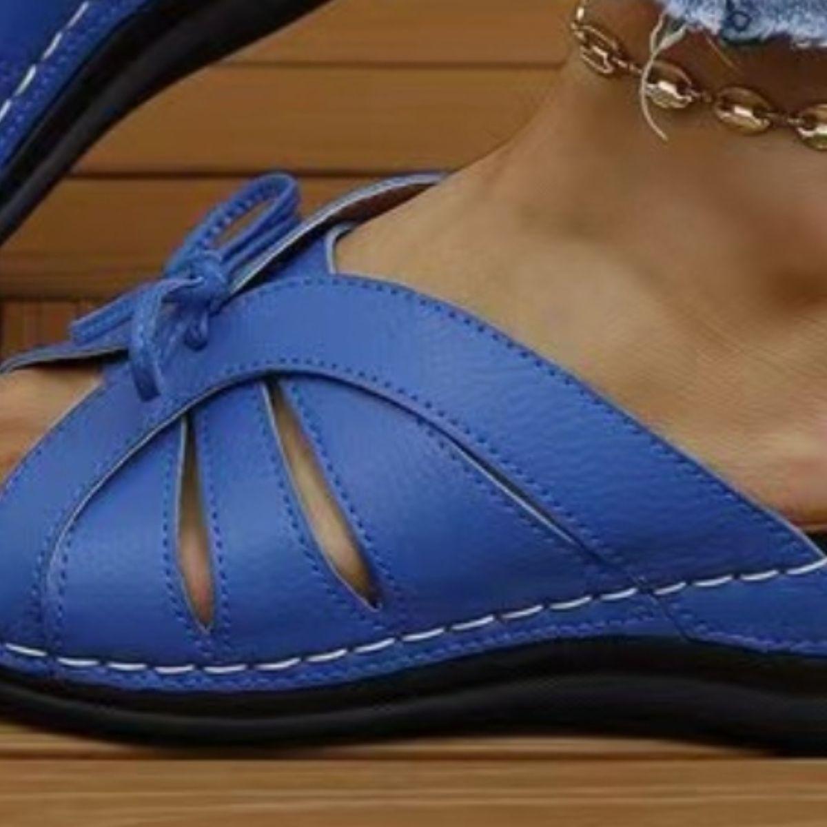 a close up of a person wearing blue sandals
