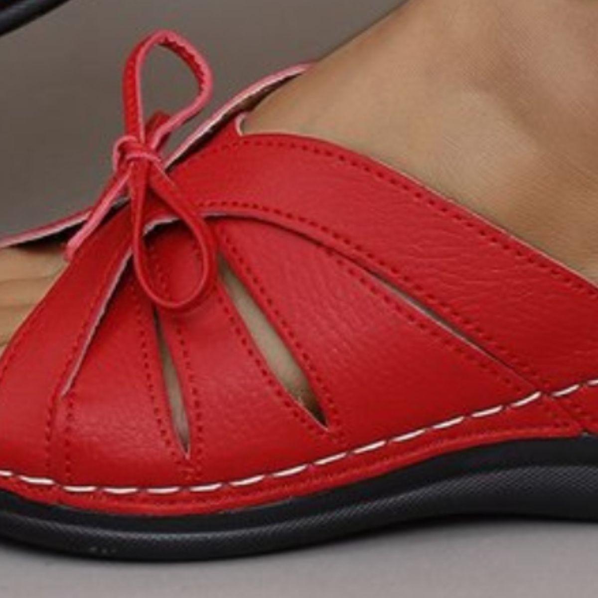 a close up of a person wearing red shoes