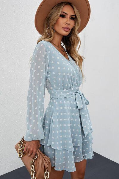 a woman wearing a blue polka dot dress