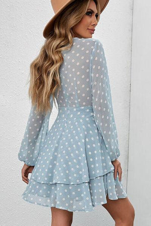 a woman wearing a blue polka dot dress