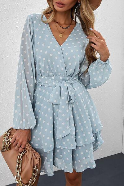 a woman wearing a blue polka dot dress