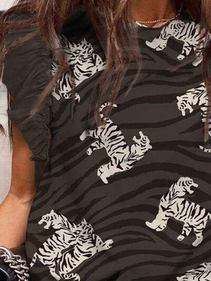 a woman with long hair wearing a tiger print shirt