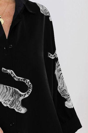 a woman wearing a black shirt with a white tiger on it