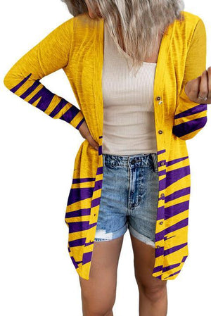 a woman wearing a yellow and purple striped cardigan