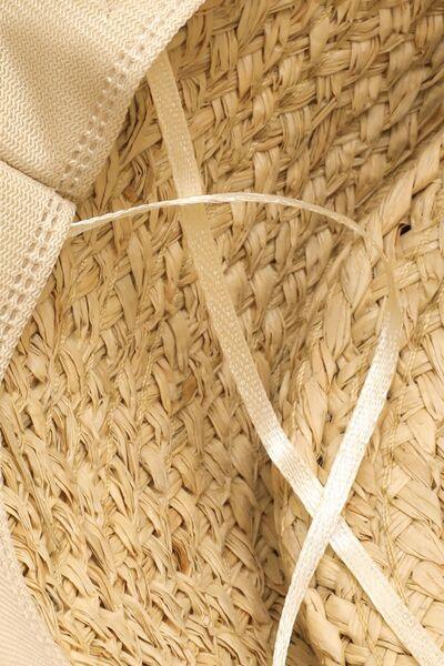 a close up of a straw hat with a white ribbon