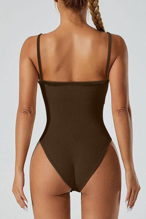 a woman in a brown swimsuit with her back to the camera