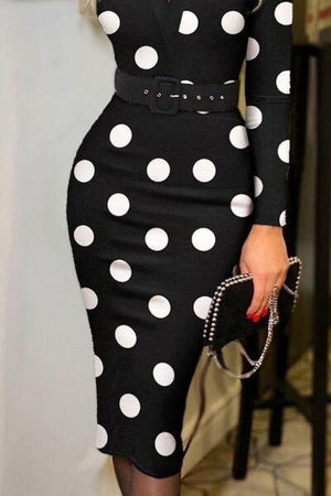 a woman wearing a black and white polka dot dress