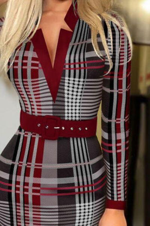 a woman wearing a red and black plaid dress