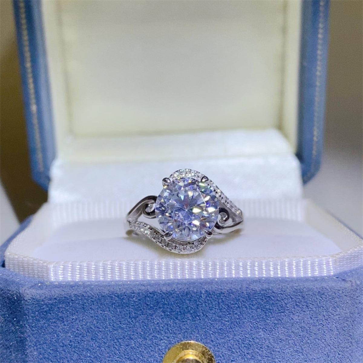 a diamond ring sits in a blue box