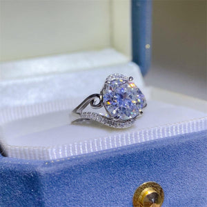 a diamond ring sits on top of a blue box