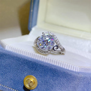 a diamond ring sitting on top of a blue box