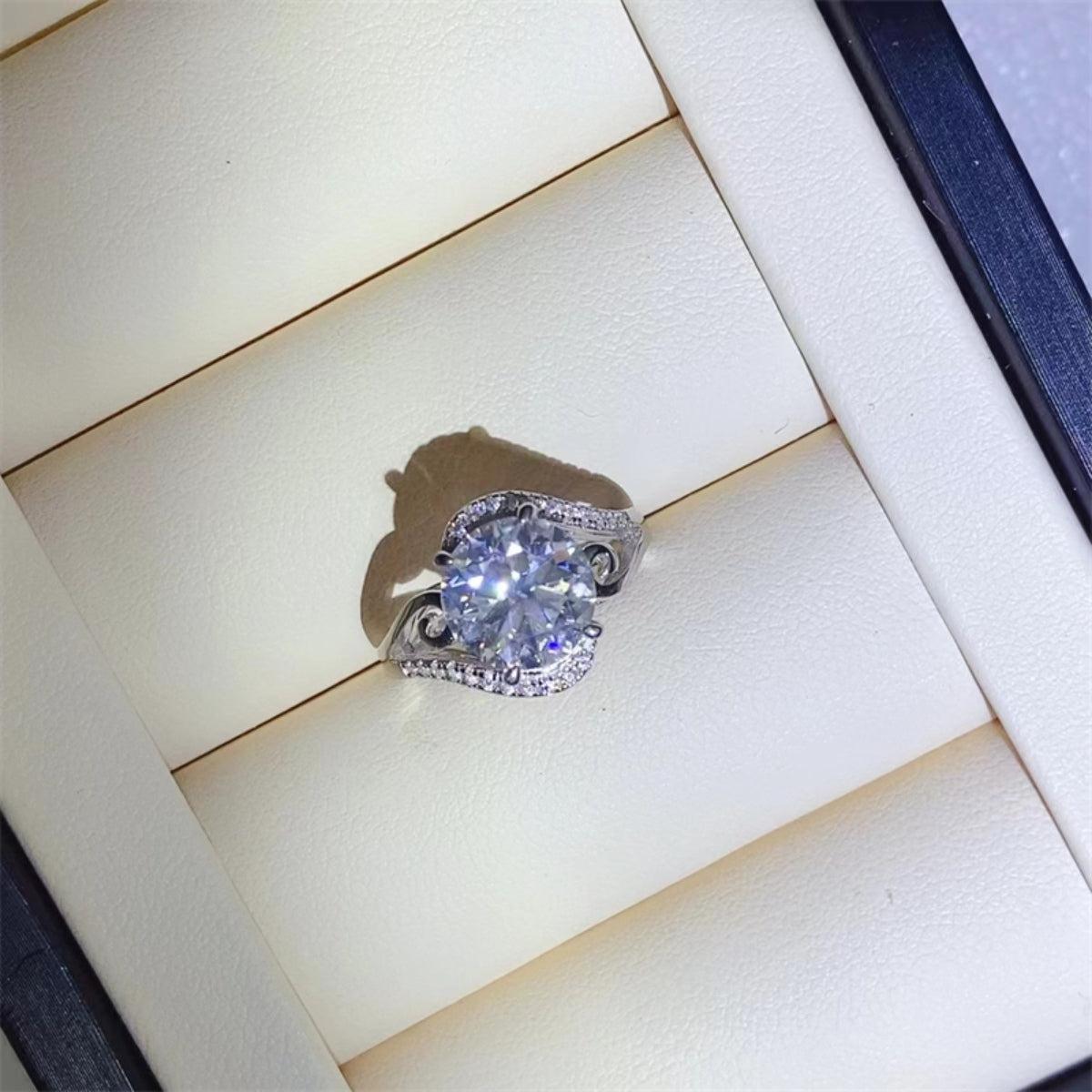 a diamond ring sitting on top of a white surface