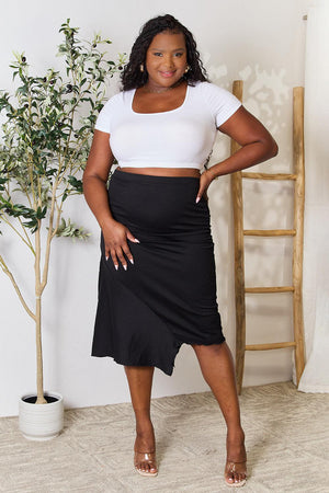 a woman in a white shirt and black skirt